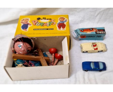 A Corgi Toys Austin Healey Sports Car 300 together with a Pelham Puppet and a Matchbox car.  