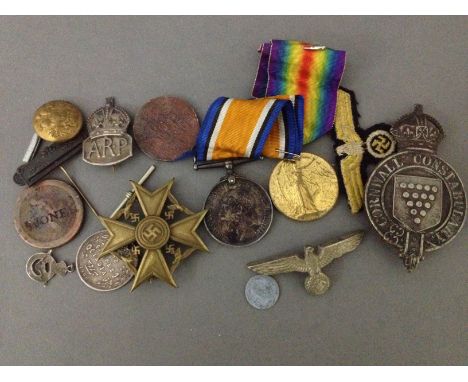 A selection of military badges and medals to include a WW1 silver medal and a "The Great War for Civilisation 1914 - 1919" me