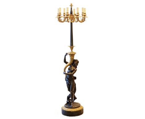  French, sculptural floor lamp made of gilded and patinated bronze for 8 candles, the fluted stem of which is gracefully supp