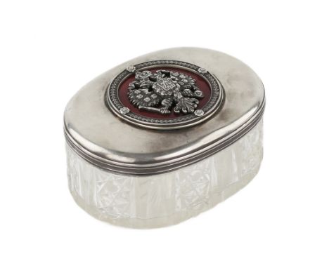 Russian crystal box of oval shape with a silver rim and a lid decorated with the coat of arms of Russia in guilloche enamel. 