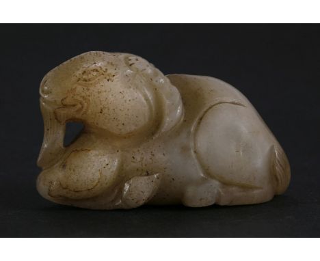 A jade Goat, possibly Ming (1368-1644), the recumbent beast with well engraved tail and beard and curled horns, the stone spe