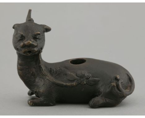 A bronze Bixie Water Dropper, Ming dynasty (1368-1644), the recumbent beast holding a lotus branch in his mouth, 8.4cm  明 铜铸辟