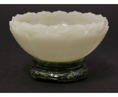 A pale-green jade Bowl, 19th/ early 20th century, carved as a lotus flower with three layers of fluted overlapping petals, th