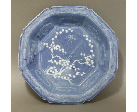 An unusual resist-decorated ko-sometsuke Bowl, Tianqi (1621-1627), the centre with white blossom and an insect, the octagonal