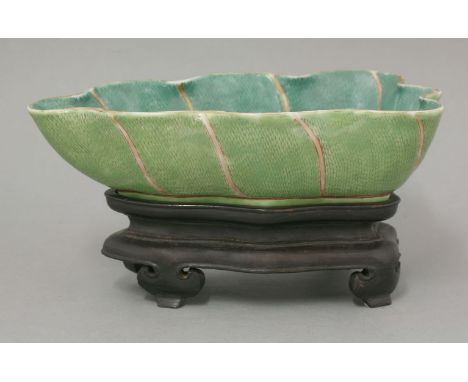 A leaf Brush Washer, mark and period of Daoguang (1821-1850), in the form of a wavy lotus leaf, the sides emerald green with 