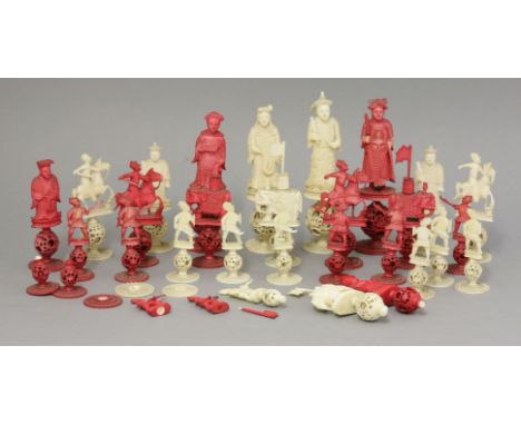 A Canton ivory Chess Set, c.1860, each piece on a puzzle ball with carved leaf base, one side stained red, the other natural,