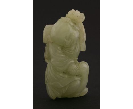 A celadon jade Boy, late 19th century, holding a lotus bud and a seed head in one hand, riding on a goose, 6cm  清十九世纪末 青玉雕童子骑