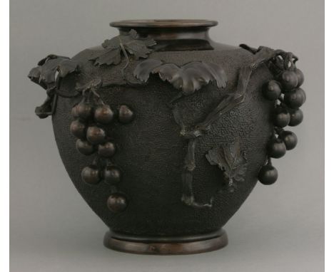 A bronze Vase, c.1920, the hammered finished baluster vase applied with fruiting vine, stamped mark, 23.5cm