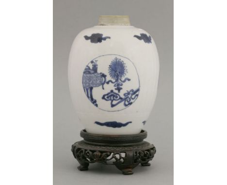 A blue and white tea canister, Kangxi, c.1700, the ribbed ovoid body painted with roundels of precious objects, between cloud