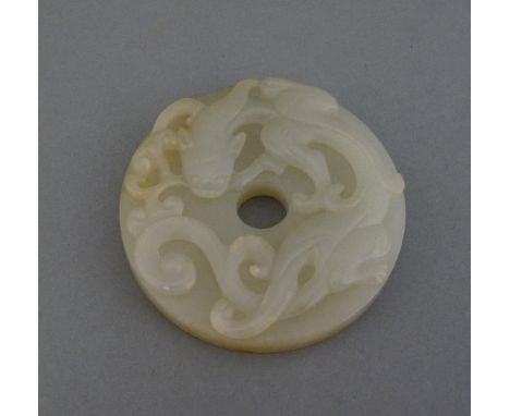 A jade Disc, 20th century, well carved with a chilong and lingzhi in his mouth, the underside with archaic scrolls, the stone