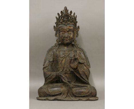 A large bronze Bodhisattva, Ming dynasty, late 16th/early 17th century, seated in dhyanasana, the left hand raised before her