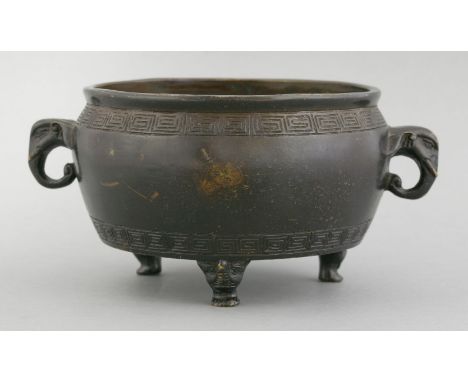 A bronze Incense Burner, 17th century, the low rounded body incised top and bottom with key fret, two sides with elephant hea