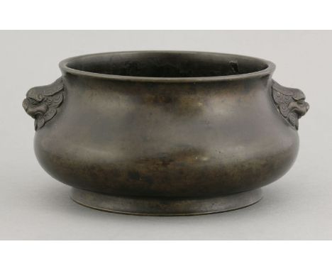 A bronze Censer, 18th century, the squat body with a slightly flared rim, lion mask handles, four character seal mark of Yong