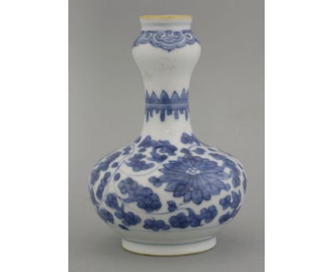 A blue and white Vase, Kangxi (1662-1722), the gourd body painted with lotus flowers and leaves, the neck with a palisade, th