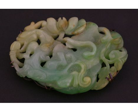 An attractive jade Pendant, late 19th century, the top carved and pierced with a chilong and lotus tendrils on a leaf, the un