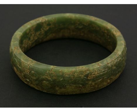 A jade Bangle, possibly Ming, in green and brown-grey carved with taotie and diaper, 8.3cm  明（可能） 碧玉带皮饕餮仿古纹手镯 