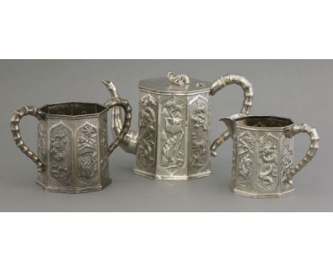 A good silver three-piece Tea Set, c.1880, each of octagonal tapered form and well engraved and repoussé on a finely hammered