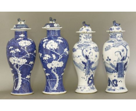 Four blue and white Vases and Covers, late 19th century, one pair painted with prunus on a cracked ice ground, the other pair