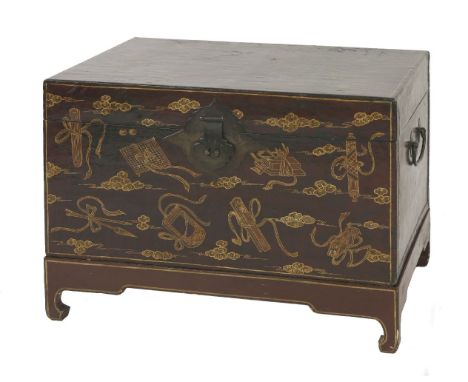 A lacquer and leather-bound travelling Trunk, 19th century, painted with precious objects amongst clouds in gilding, wrought 