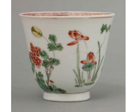 A fine enamelled Wine Cup, Kangxi (1662-1722), painted with lotus, chrysanthemum, prunus and peony in clear enamels including