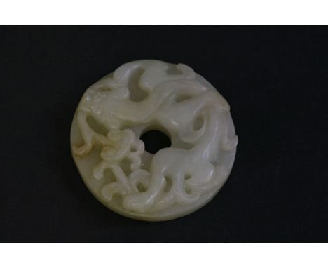 A jade Bi Disc, 20th century, carved with a chilong, a lingzhi in his mouth, the underside with archaic scrolls, 3.8cm  二十世纪 