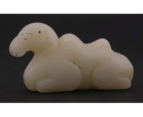 A jade Bactrian camel brush rest, 20th century, the beast at rest, the stone white to pale green, 8.2cm 