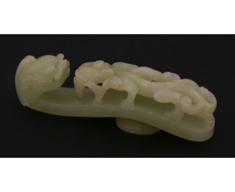 A celadon jade Belt Hook, 20th century, of typical form, one end with a dragon head, the other with a bifid tailed chilong, 7