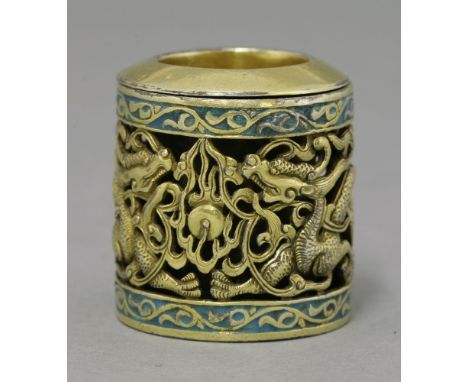 An unusual enamelled and silver gilt Archer's Ring, 20th century, the central panel with wreathing dragons amongst flames and