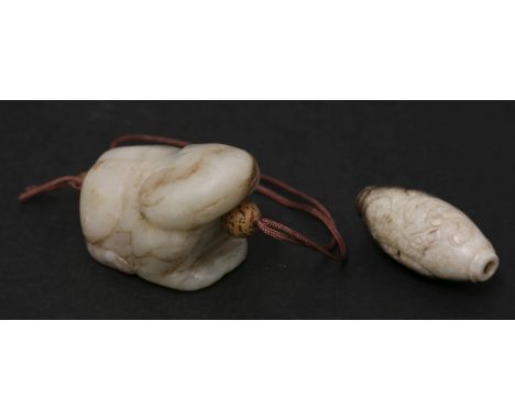 A jade bead, 19th/20th century, carved in the white and black stone with a chilong with cat-like head, 3.8cm, and another jad