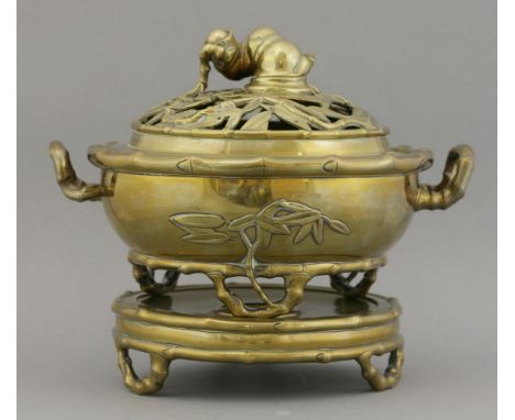 A bronze Incense Burner, early 20th century, the bowl with twin bamboo handles and on three feet, the stand also bamboo mould