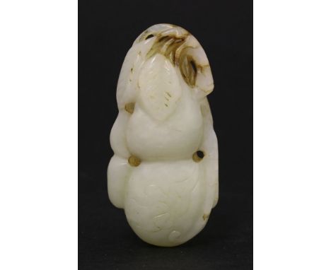 A jade Pendant, 20th century, the pale-green double-gourd with leaves, the stem with a brown inclusion and the base with an e
