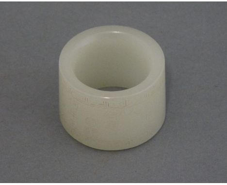 A pale green jade Archer's Ring, 20th century, the exterior carved with poem of Qianlong within key fret bands, 3.1cm
