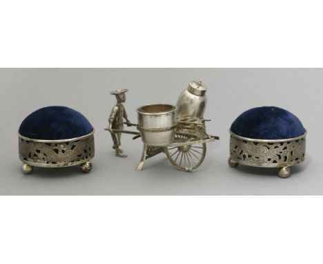 A silver condiment, early 20th century, modelled as a merchant pushing his cart, stamped Sing Fat and Jieji, 12cm, and a pair