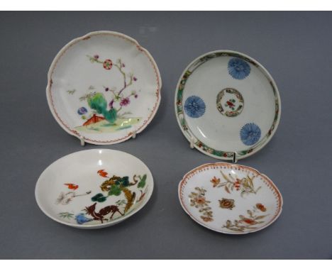 An attractive famille verte saucer, Kangxi, painted in underglaze blue with three pom-poms and with borders of seeded green, 