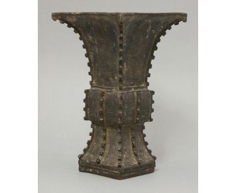 A bronze Gu, 18th/19th century, of square section with notched edges, cast with bladed panels of ruyi, taotie and key fret, d