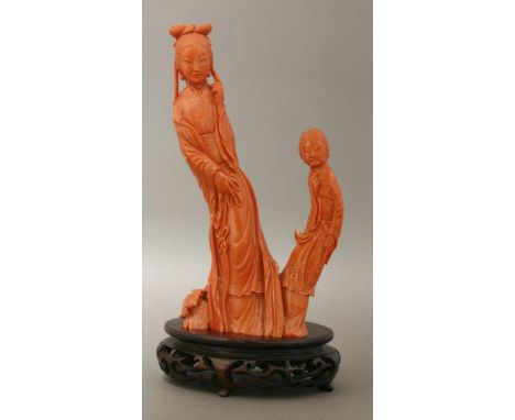 A large coral Carving, 20th century, of a maiden immortal standing in tasselled gown, an attendant by her side, the base with