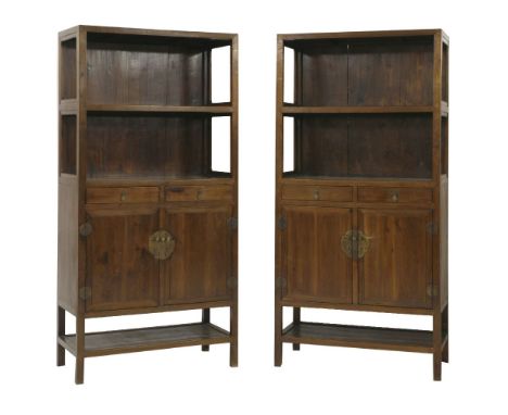 A pair of elm Cabinets (Lianggegui), 19th century, the open shelves over two short drawers and cupboard doors, above a lower 