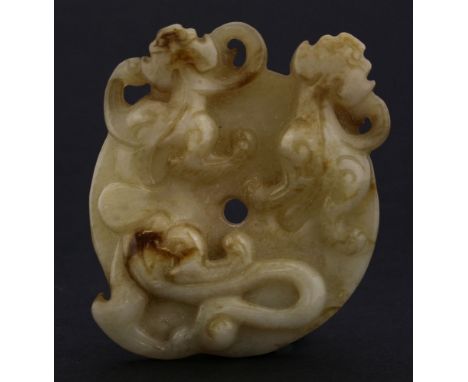 An unusual jade Disc, possibly Ming (1368-1644), the circular disc chased with archaic channels based on a mirror, the top wi