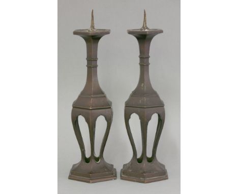 An attractive pair of bronze Candlesticks, 19th century, each of exaggerated Ming form and hexagonal section on arcaded legs,