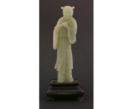 A celadon jade Han Xiangzi, late Qing, the well carved Daoist Immortal, standing smiling and holding his flute, the figure 16
