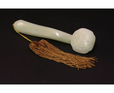 A celadon jade Sceptre, 20th century, the ruyi-shaped head carved in low relief with five bats surrounding a shou, the stem i