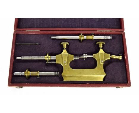 Antique brass and steel Jacot tool with accessories, within a fitted gilt tooled leather case