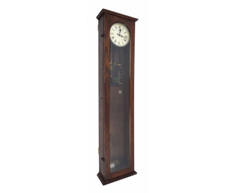 Synchrome electric master clock, the 6.5" silvered dial within a glazed oak case, 50.5" high (pendulum)