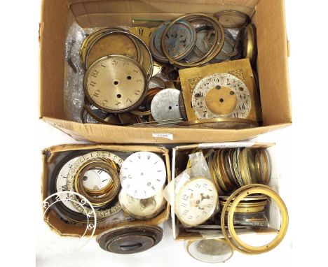 Two boxes of various clock spares, including dials, bezels, movements and assorted clock weights