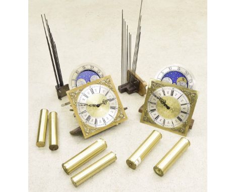 Two Hermle three train longcase clock movements, both with 11" arched dials and moon phase (with six weights, but no cases) (
