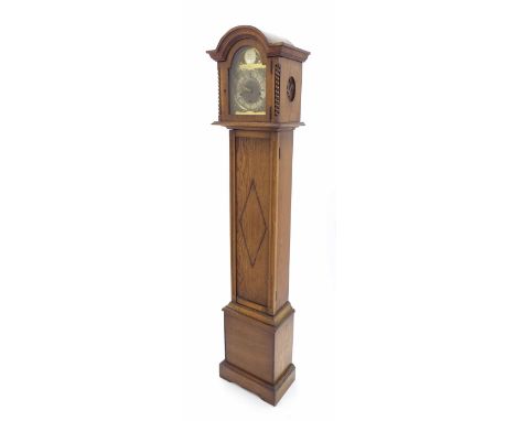 Oak grandmother three train longcase clock, the 8" brass arched dial with silvered chapter ring enclosing a matted centre, th