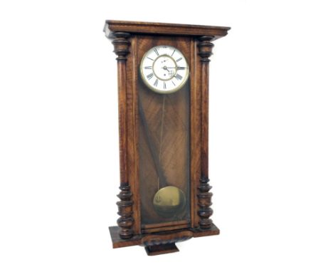Walnut single weight Vienna regulator wall clock, the 7" white dial with subsidiary seconds dial, within a glazed and turned 