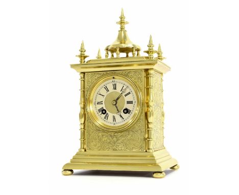 French brass two train mantel clock striking on a gong, the 3.25" dial within a pillared foliate engraved case surmounted by 