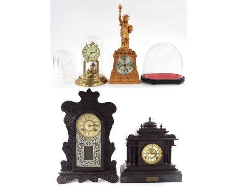 Ansonia gingerbread shelf clock striking on a gong, 23" high; also a black slate two train mantel clock, gilded spelter Statu