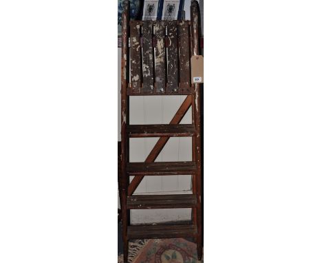 A vintage four tread folding step ladder